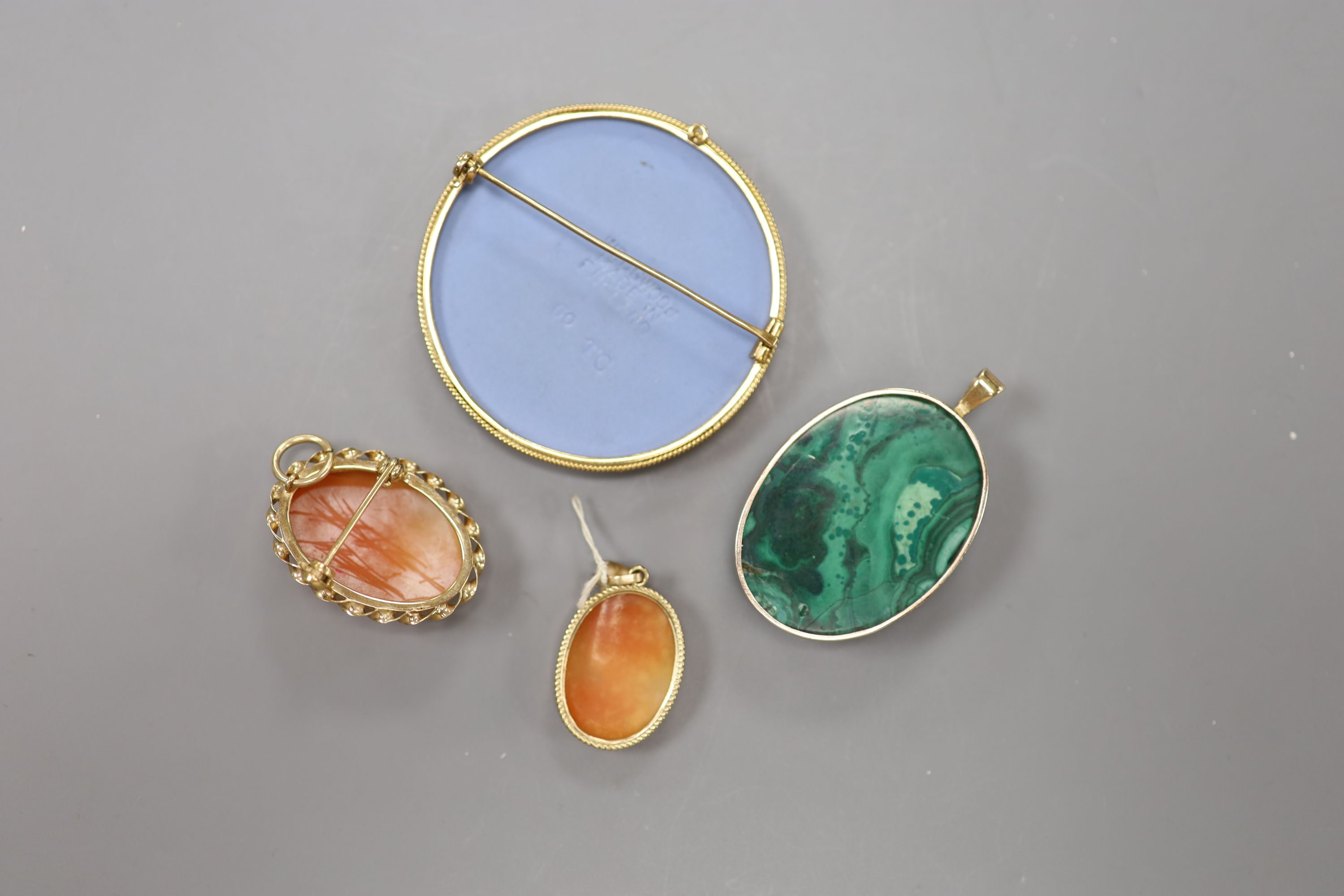 A modern 9ct gold mounted Wedgwood brooch, 49mm, a similar cameo brooch, a 9ct and cameo pendant and yellow metal and malachite pendant(a.f.)